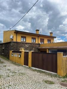 a house with a fence and a building at Casa de Campo - Vila Boa in Vila Boa +18 photos