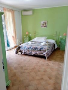 1 dormitorio con 1 cama y paredes verdes en Agriturismo dal Pastore en Follonica