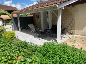 a patio with chairs and a table and a building at La Bergerie in Thodure