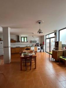a living room with a table and a kitchen at Casa de Campo - Vila Boa in Vila Boa
