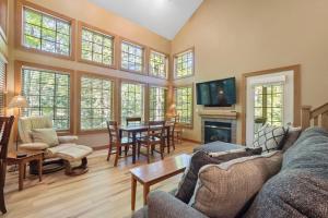 a living room with a couch and a table at 666 Disciples Village Condo in Boyne Falls
