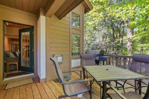 a patio with a table and chairs on a porch at 666 Disciples Village Condo in Boyne Falls