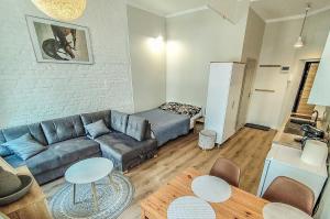 ein Wohnzimmer mit einem Sofa und einem Tisch in der Unterkunft Mazurska Apartments in Stettin