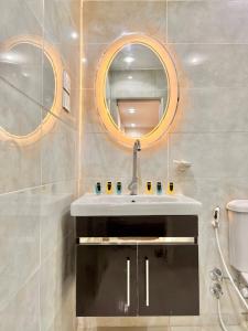 a bathroom with a sink and a mirror at Dima Pyramids View in Cairo