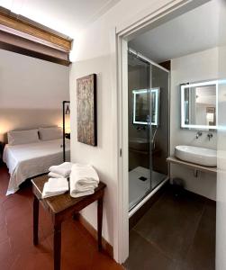 a bedroom with a bed and a bathroom with a sink at Affittacamere Medusa in Florence