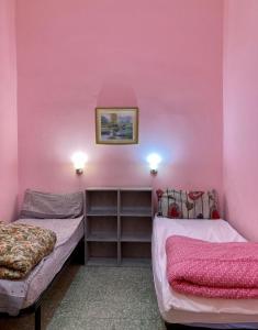 מיטה או מיטות בחדר ב-Affitti brevi "Max FORTUNA"