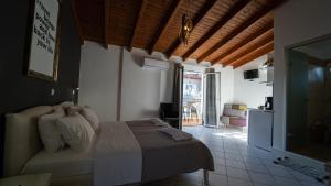 a bedroom with a bed and a living room at Studios Vaso - Center in Parga