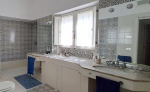 a bathroom with a sink and a toilet at Villa Francesca - Camere con giardino in Castellaneta +63 photos
