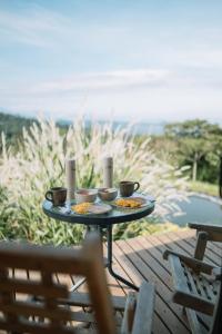 a table with two plates of food on a patio at Casa De La Ruta, Glamping in Zipacón +28 photos
