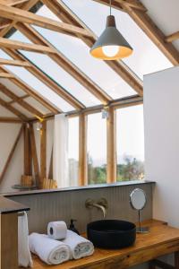 a bathroom with a sink and a large window at Casa De La Ruta, Glamping in Zipacón