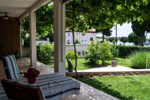 a table on a porch with a view of a house at Apartment Derossi in Umag