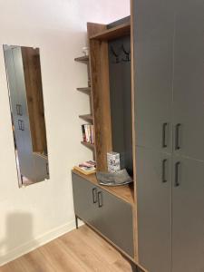 a room with a dresser and a mirror at Studio Cosy en cœur de ville in Pau +3 photos