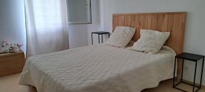 a bedroom with a bed with white sheets and pillows at Les naïades C7, jusqu'à 6 personnes in Avène +11 photos
