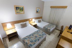 En eller flere senger på et rom på Hotel Dan Inn Franca & Convenções