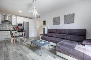 ein Wohnzimmer mit einem Sofa und einem Tisch in der Unterkunft Apartamento moderno a 10 minutos del centro in Ogíjares