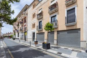 a street with two garage doors on a building at Dreaming Ogíjares in Ogíjares