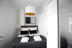 a bedroom with a bed with two pillows on it at ML Apartments in Vieste
