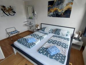 a bedroom with a large bed with two pillows at Landgasthof "Hotel zum Norden" in Jagel