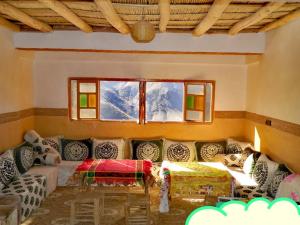 a living room with a couch and a window at riad atlas imnane in Imlil