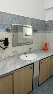 a bathroom counter with a sink and a mirror at Anna House Dhermi in Dhërmi