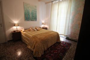 a bedroom with a bed with a teddy bear on it at Villa Vento Largo, Casa Irene in Ventimiglia