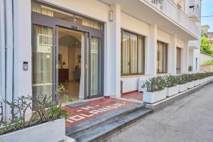 an entrance to a white building with a glass door at HOTEL JOLANDA in Bellaria-Igea Marina