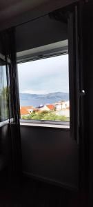 a window in a room with a view at Apartments Ita - Postira in Postira