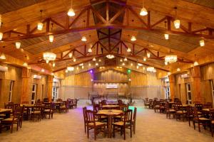 a dining hall with tables and chairs in it at Bagaicha Adventure Resort in Maruwā Ghāt