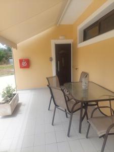 a dining room with a table and chairs at Sea Side Studios in Tsilivi