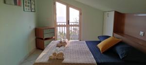 a bedroom with a bed with flip flops on it at Casa Marecielo - Attico con terrazza panoramica vista mare in Longobardi