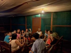 a group of people sitting in a room at Jungle Explorer Lodge in Mazán