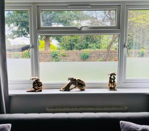 a pair of shoes sitting on a window sill at One Bedroom Flat in Chiswick W4 in London