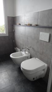 a bathroom with a toilet and a sink at Villa Vento Largo, Casa Irene in Ventimiglia