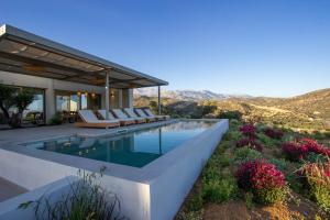 a villa with a swimming pool with a view at Villa Ninemia in Agia Galini
