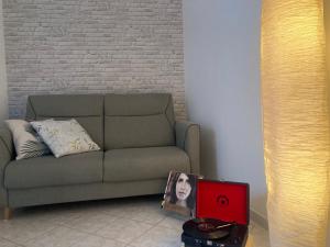 a living room with a couch and a picture of a person at Maggie ‘s home in Castellana Grotte