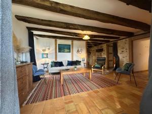 a living room with a couch and a table at Gites Boutique in Villamblard +102 photos