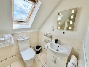 a bathroom with a white toilet and a sink at Whitestrand B&B in Malin Head