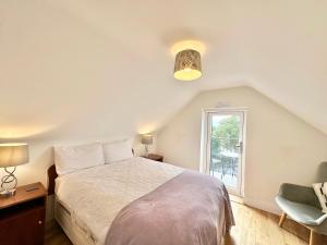 a bedroom with a large bed and a window at Whitestrand B&B in Malin Head