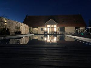 a house with a swimming pool at night at Le domaine du Quercy in Padirac