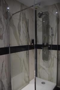 a bathroom with a shower with a glass door at Lit en Loire in Saint-Cyr-sur-Loire +56 photos