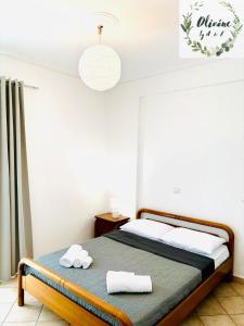 a bedroom with a bed with towels on it at Olivóne apt, by A & F in Igoumenitsa