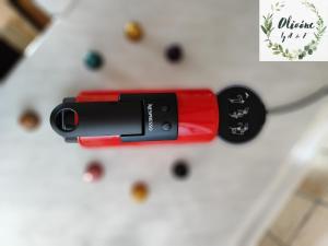 a red lipstick sitting on a table with a christmas tree at Olivóne apt, by A & F in Igoumenitsa