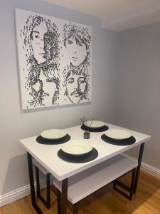 a white table with four plates on top of it at Central Windsor in Windsor