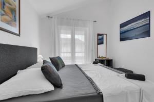 Postel nebo postele na pokoji v ubytování Apartmani Vanda