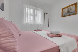 Postel nebo postele na pokoji v ubytování Apartmani Vanda