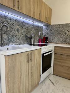 a kitchen with a sink and a stove at Sugar High in Belgrade