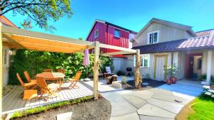 a patio with a table and chairs and a house at Mercury House, Cathedral View ! Free Parking ! in Trondheim