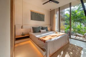 a bedroom with a bed and a large window at Amazing 1BR Tulum Jungle with Restaurant, Pool and Gym in Tulum +30 photos