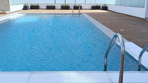 a swimming pool with blue water in a building at Larvella Estia Luxury Suites in Larnaca