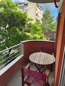 a table and two chairs on a balcony at Prime City Apartments in Skopje
